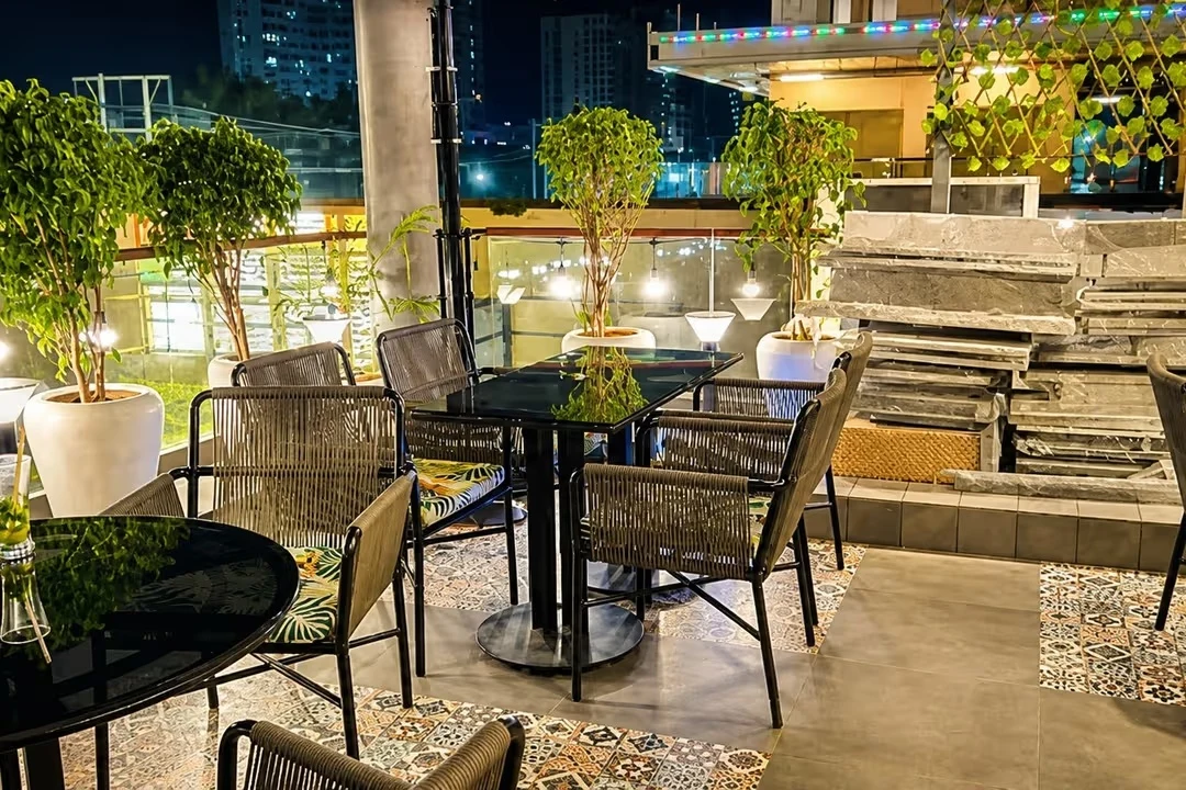 Terrace tables and plants illuminated for evening dining
